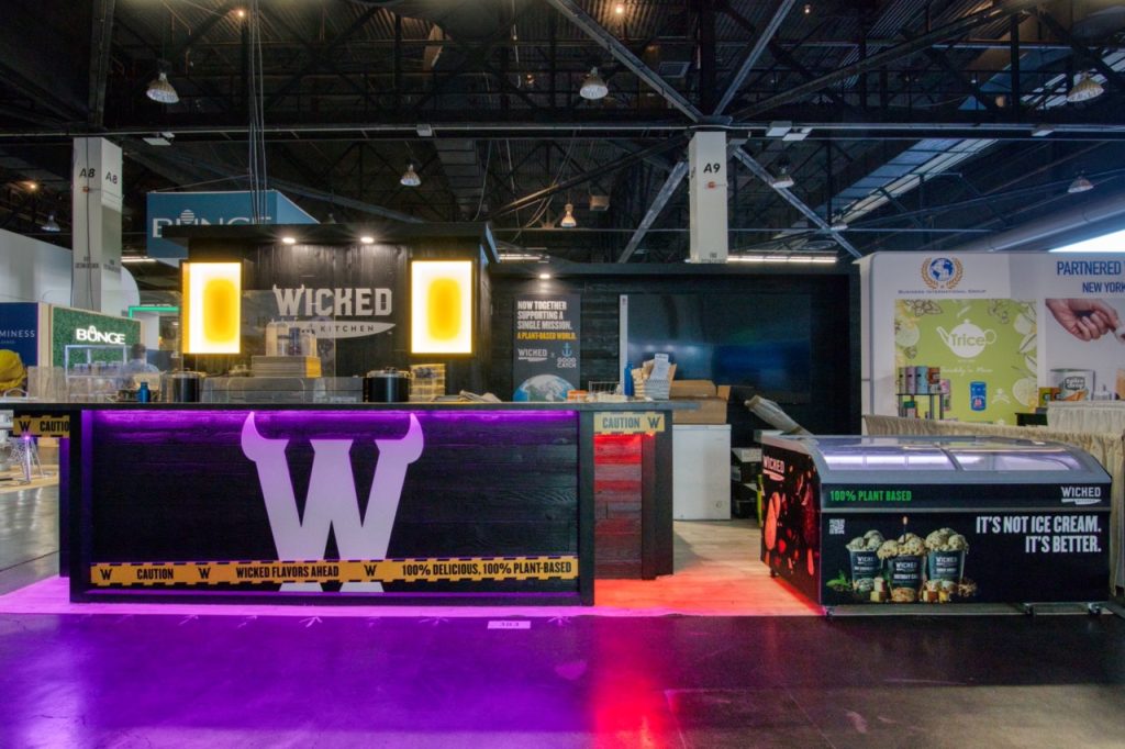 A tradeshow exhibit with purple and red lighting